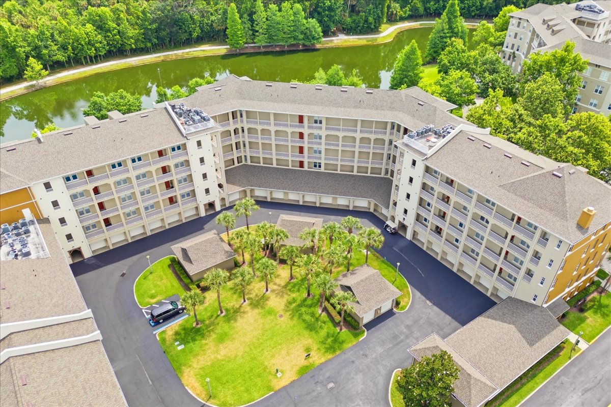 Aerial pondside view of the building with rear pond and forest beyond